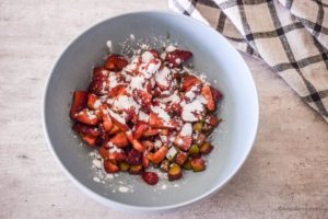 chopped berries in a bowl with arrowroot powder sprinkled overtop
