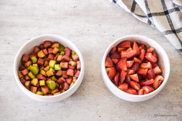 rhubarb and sliced strawberries in two separate white bowls