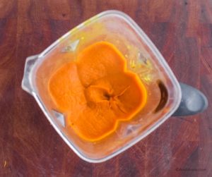 pureed carrot ginger turmeric soup in a blender