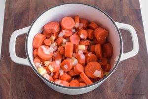 chopped carrots, onion, garlic in a white dutch oven.