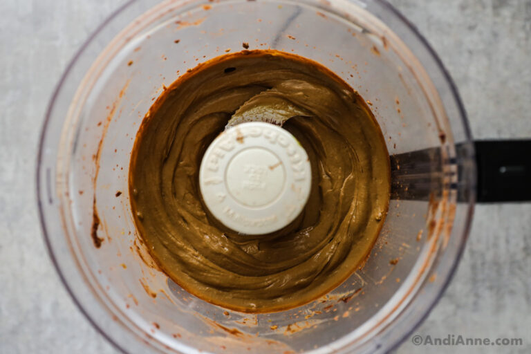 Smooth chocolate avocado pudding recipe inside a food processor container.