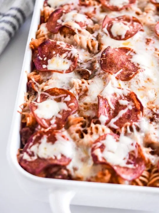 pizza pasta bake in a white casserole dish - close up detail