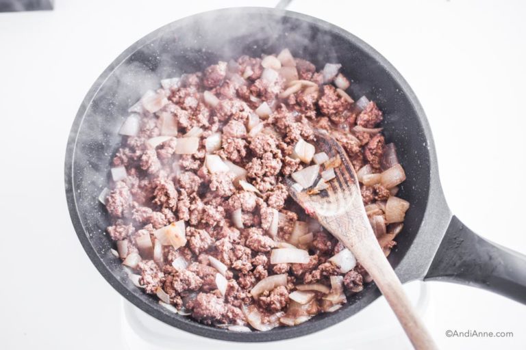 ground beef and onion cooking in a frying pan