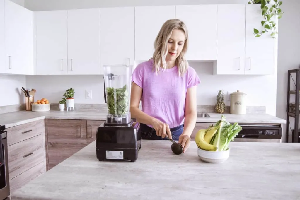 Andi slicing an avocado to make a smoothie in the blender