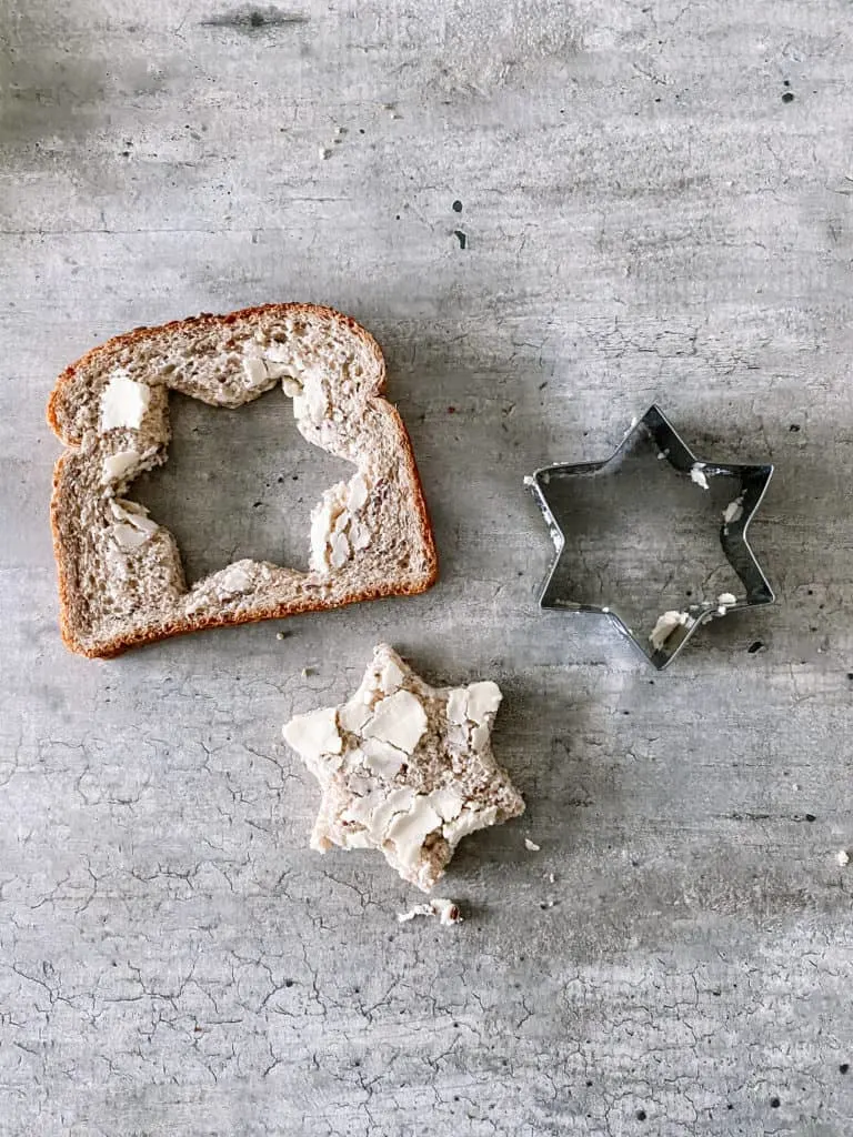cut out the center of the bread with a cookie cutter shape