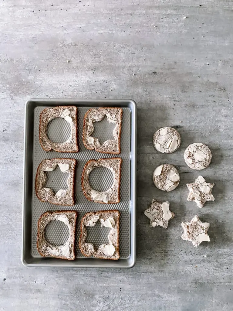 pieces of bread with the centers cut out in circle and star shapes