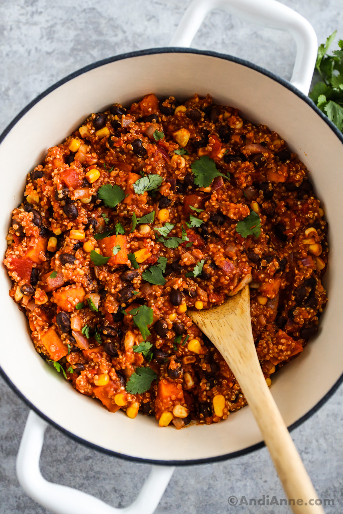 A big white pot of quinoa chili with corn, black beans and sweet potatoes.