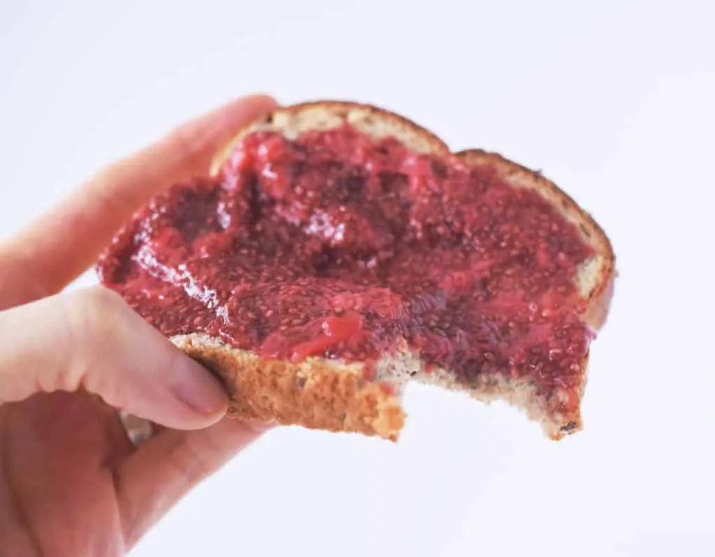 hand holding chia jam on toast