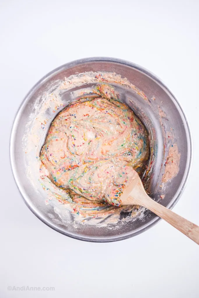 sprinkle pancake batter in steel bowl with wooden spoon