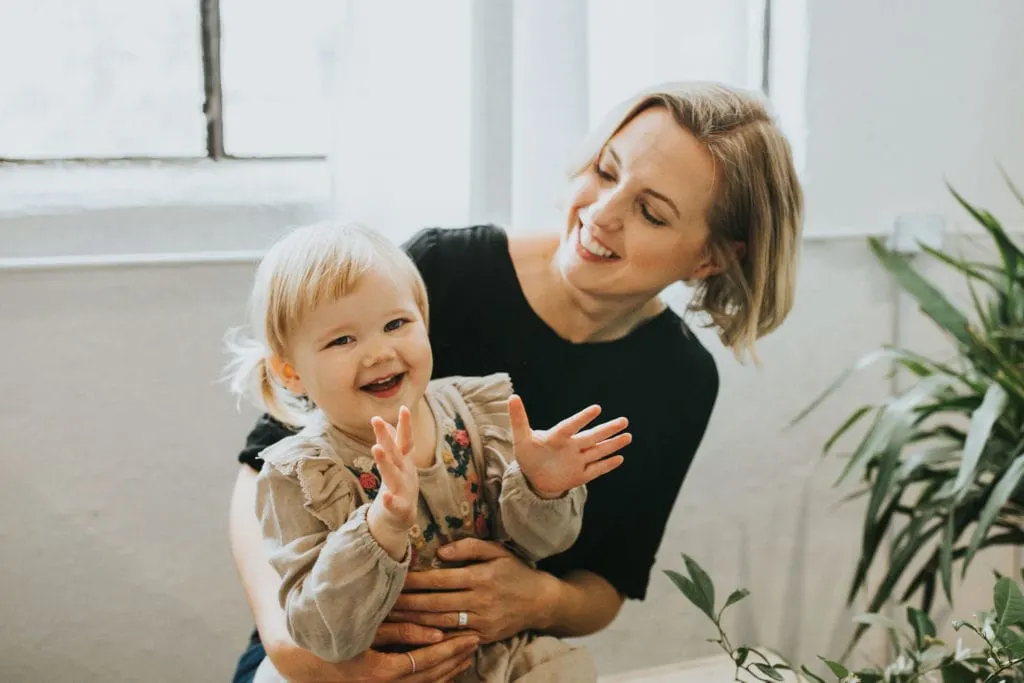 Picture of Andi and her daughter laughing together