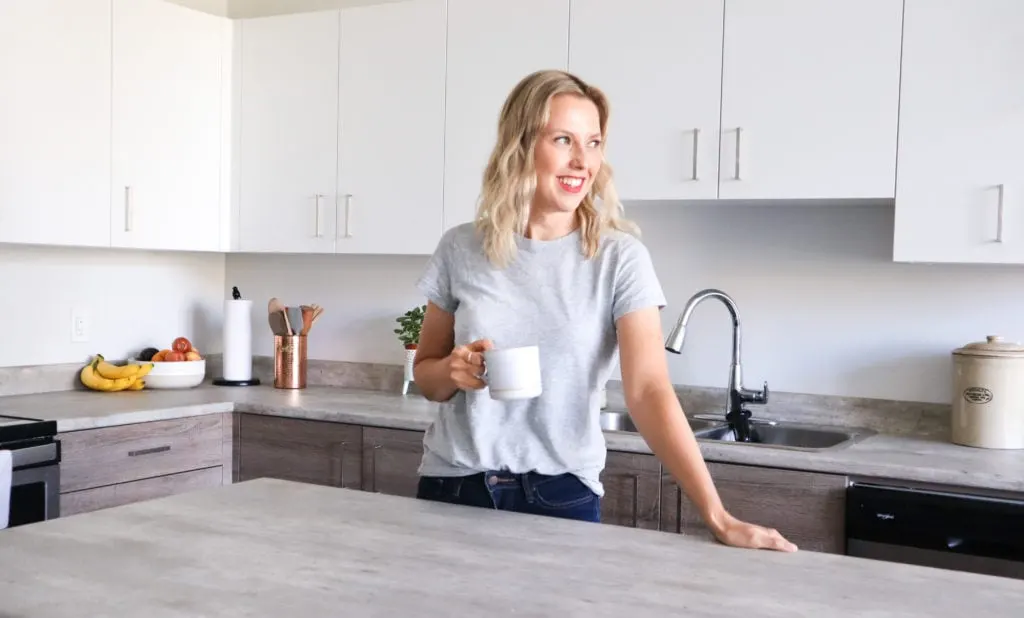 Picture of Andi in her kitchen with coffee cup