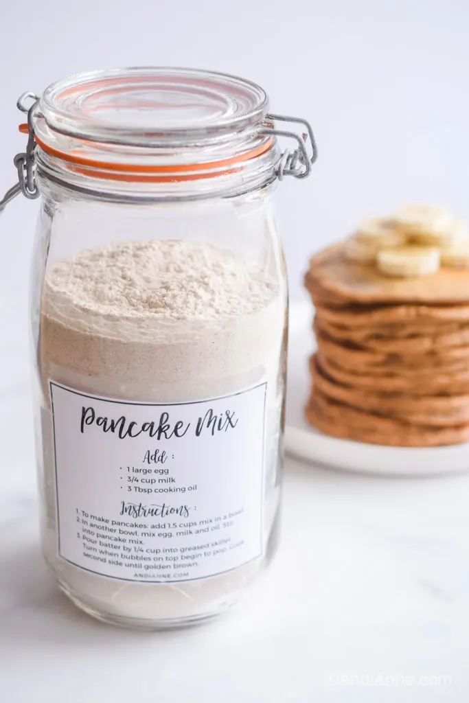 homemade pancake mix in jar with label on front and stacked pancakes in background