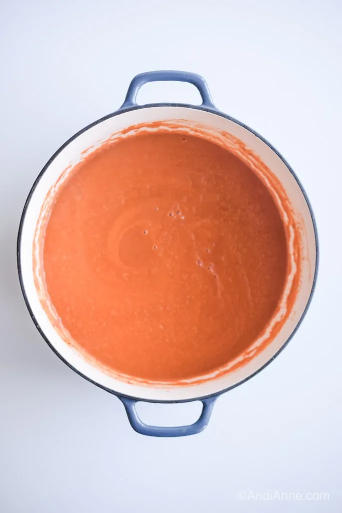 tomato soup in a large blue dutch oven pot
