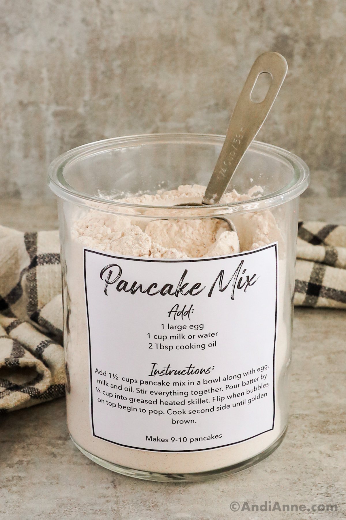 Close up of a jar of dry pancake mix with a label on the front showing instructions. 