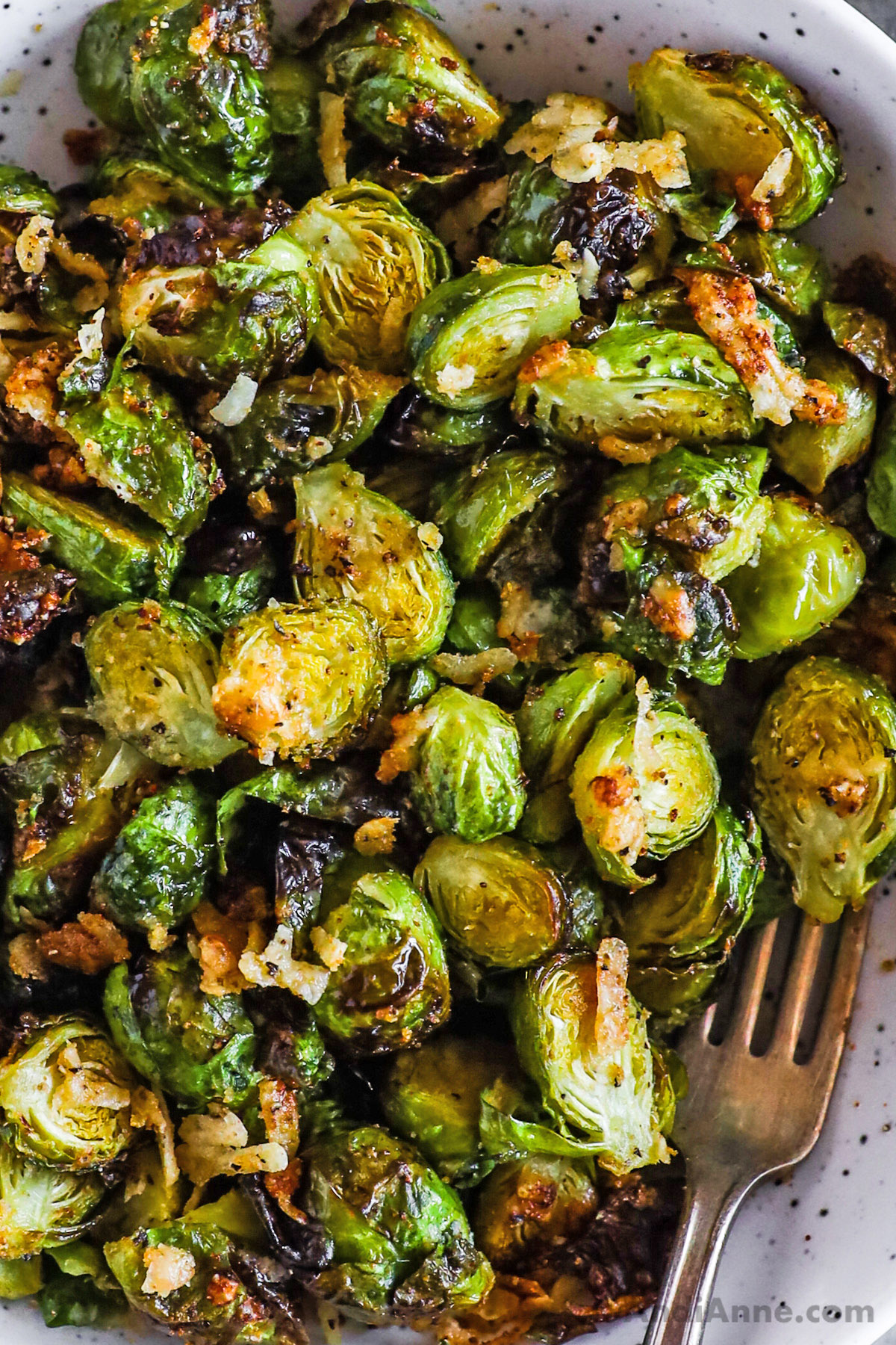 A bowl of brussels sprouts close up and a fork.