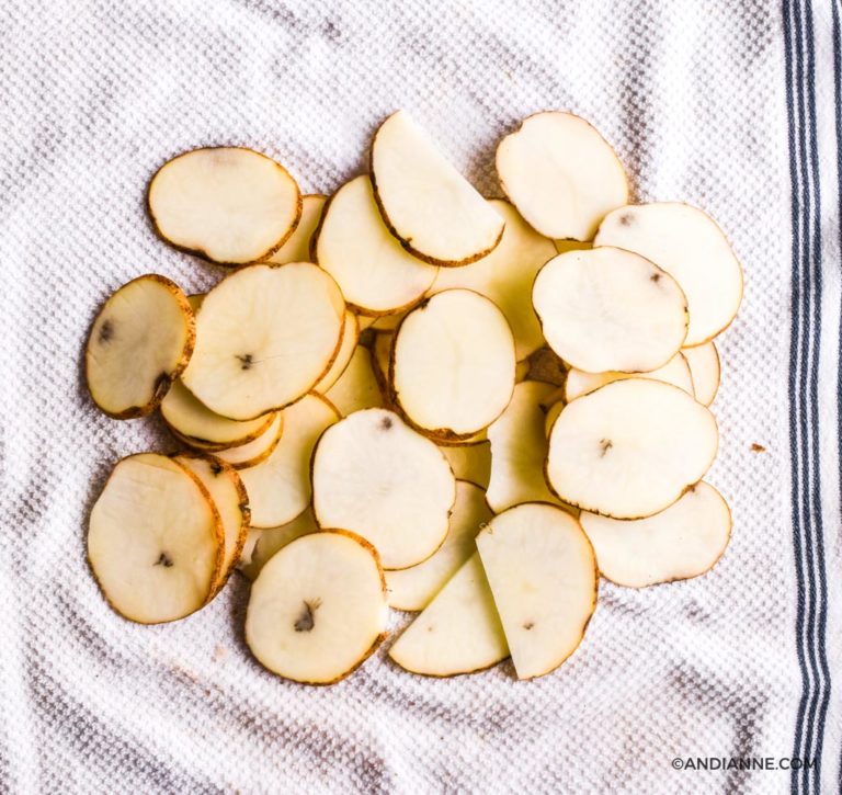sliced potatoes on a white dish towel