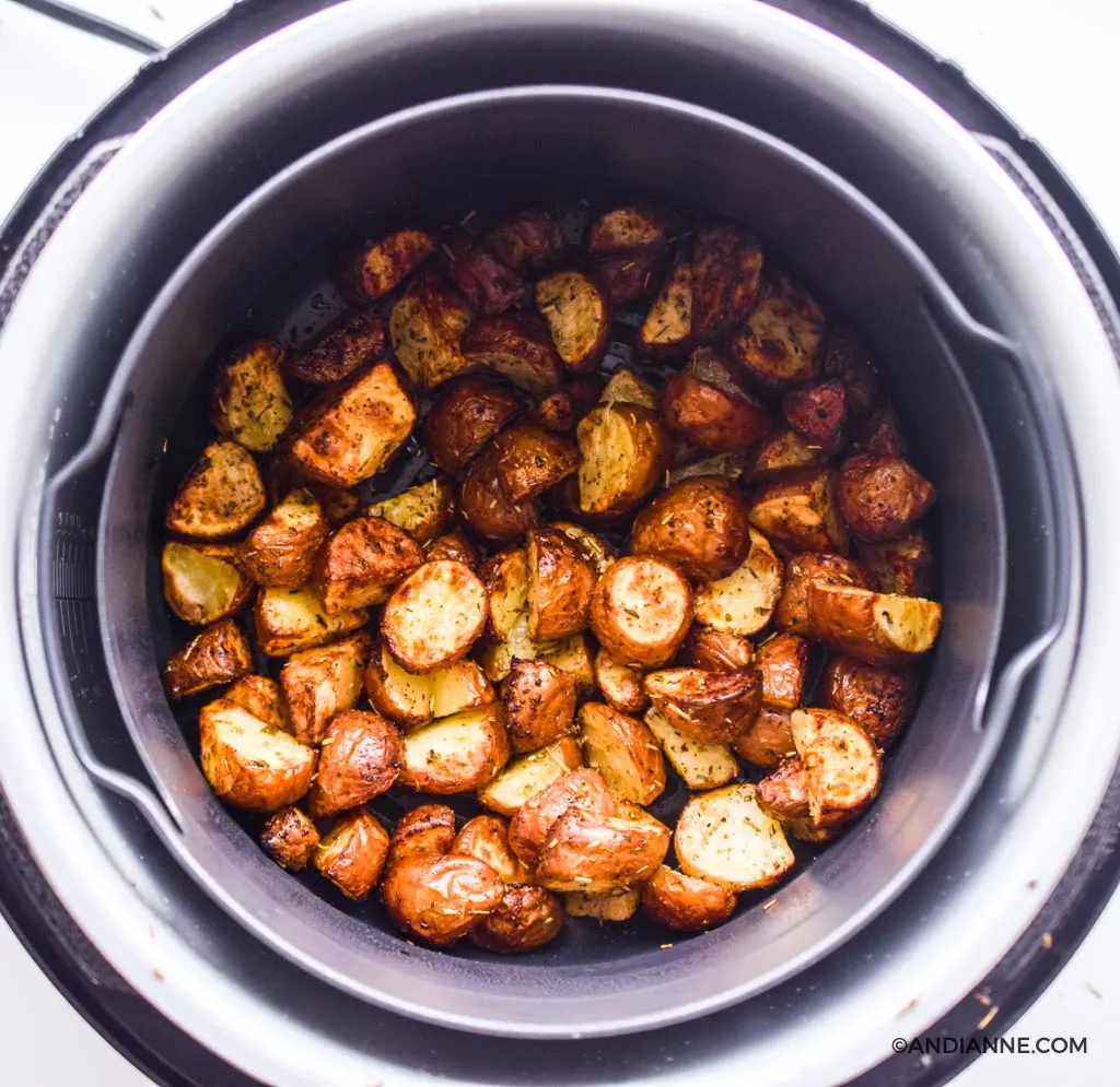 cooked crispy potatoes inside an air fryer