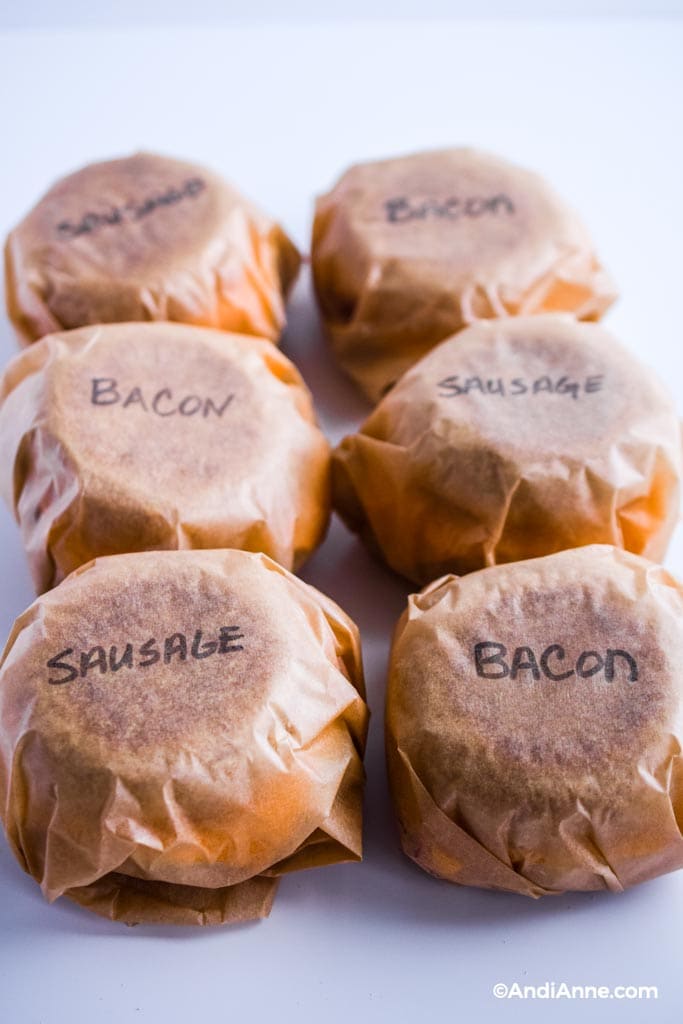freezer breakfast sausage muffins wrapped in parchment paper and labeled with bacon or sausage.