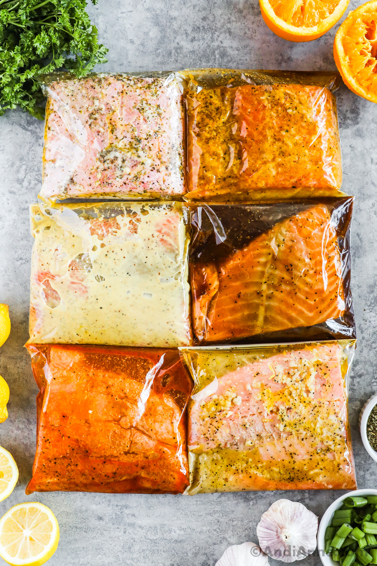 six pieces of salmon in bags with various marinades.
