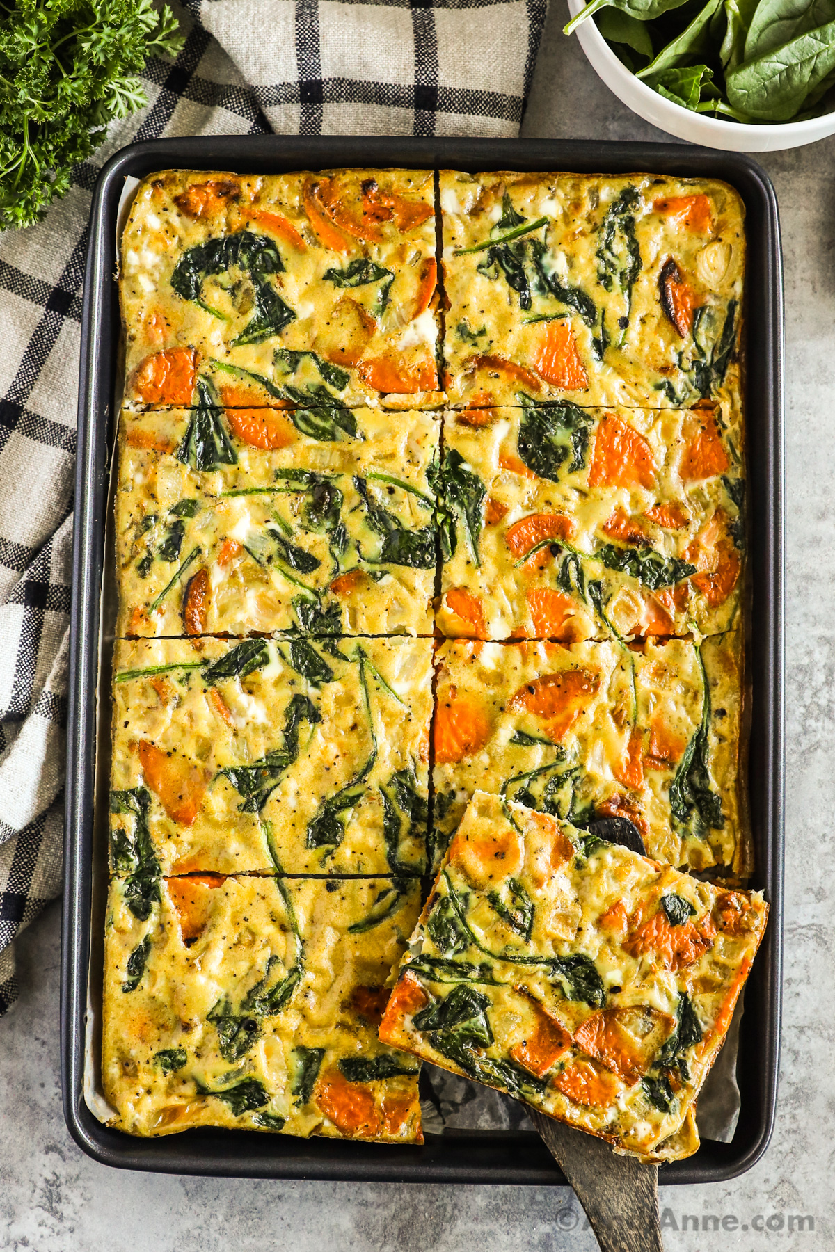 Sheet pan with a spinach and sweet potato omelette inside.