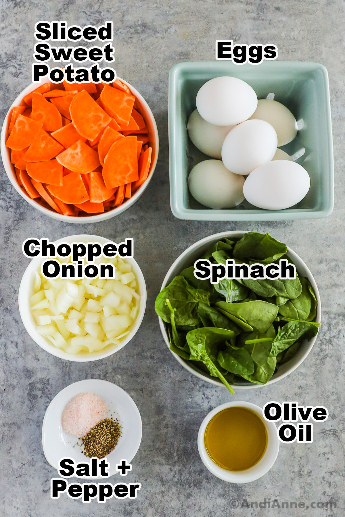 Recipe ingredients including slices of sweet potato, white eggs, chopped onion, spinach, olive oil, salt and pepper.