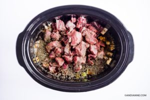 raw beef chunks in slow cooker with broth and other ingreidnets