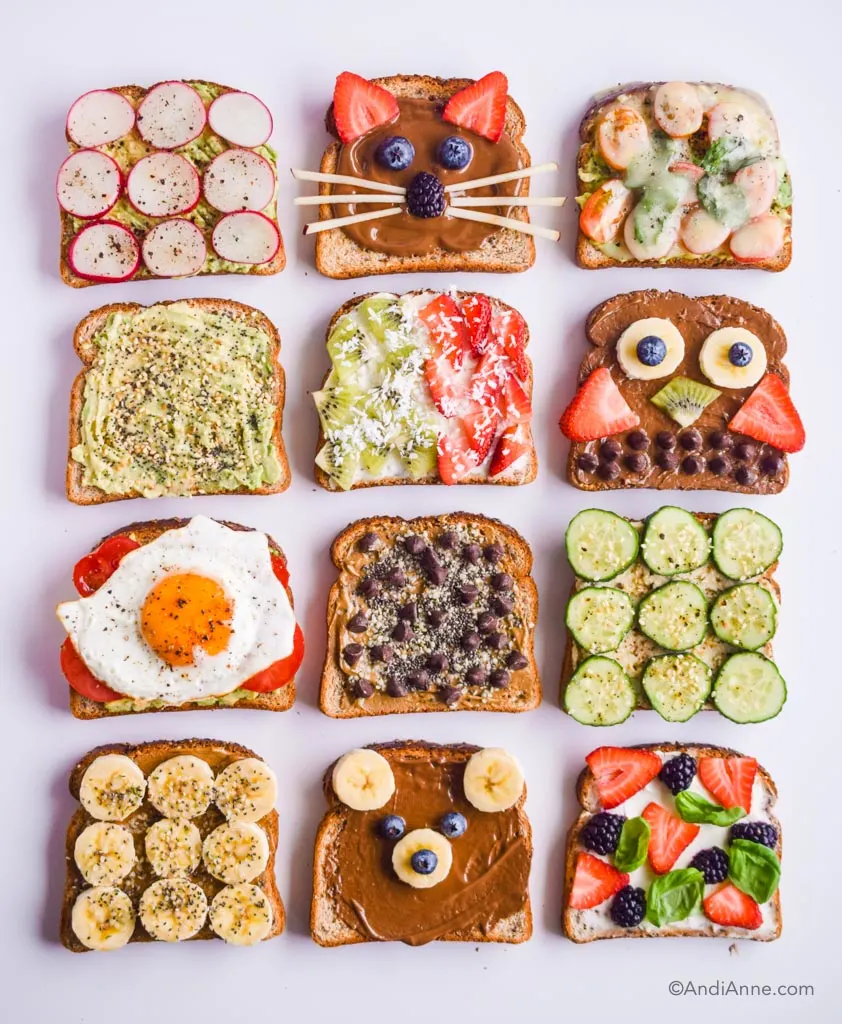 Looking down at 12 slices of toast with various toppings including mashed avocado, fried egg, sliced vegetables, and three with animal shapes made out of fruit and chocolate chips. 