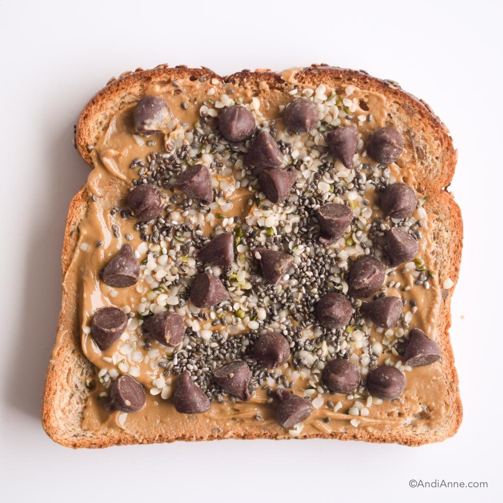 nut butter, hemp seeds, chia seeds and dark chocolate chips on toast