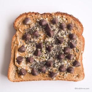 nut butter on toast sprinkled with hemp seeds, chia seeds and dark chocolate chips
