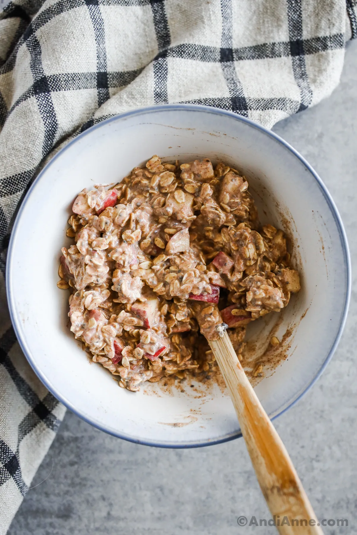 A bowl of apple cinnamon overnight oats recipe with a spoon.