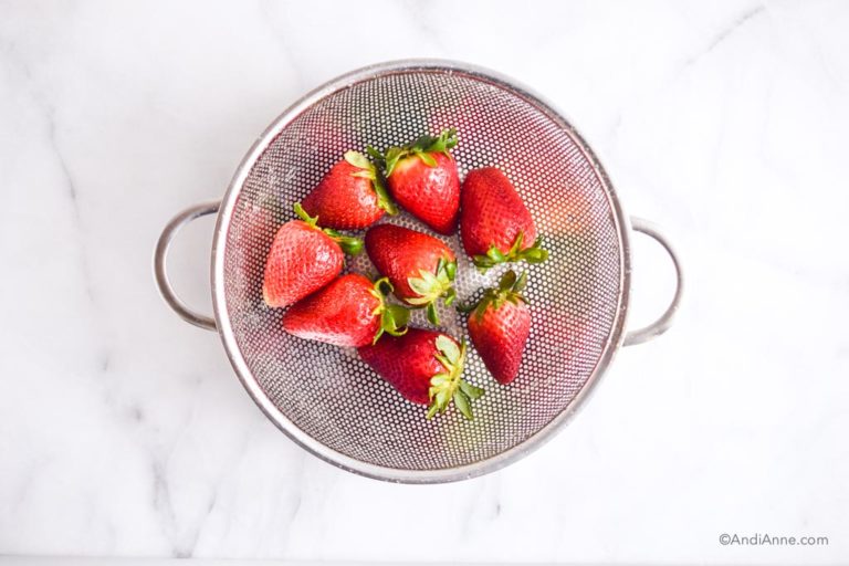 strawberries in a metal strainer
