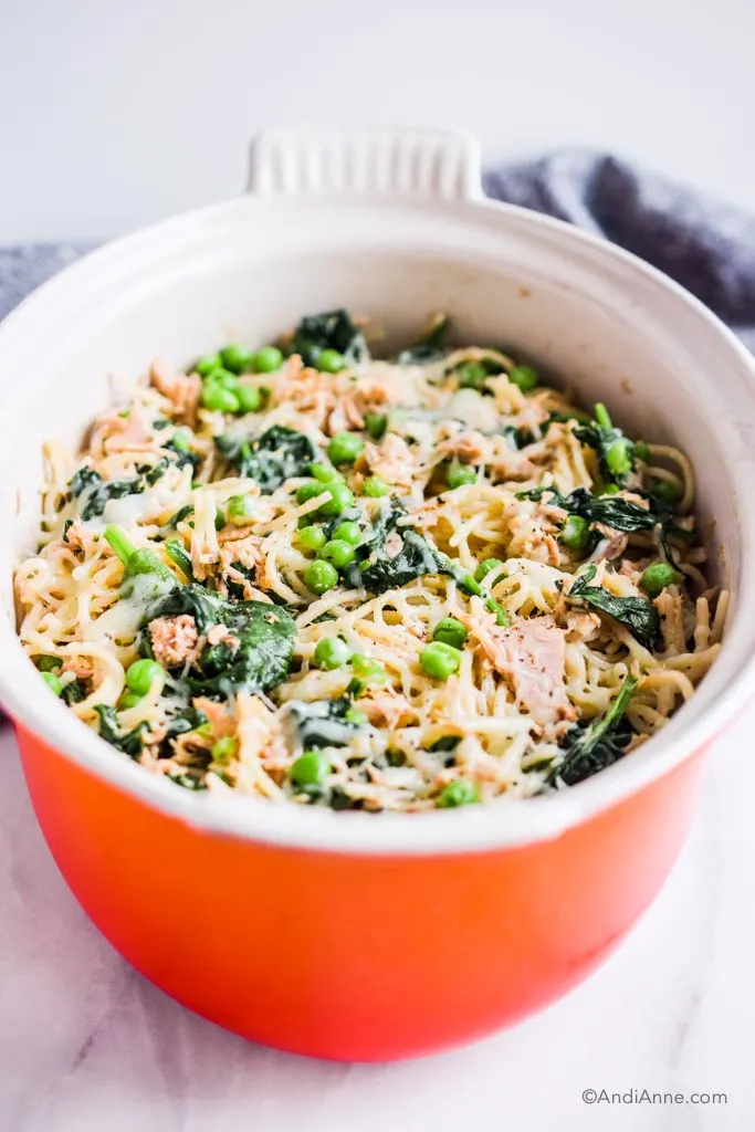 Orange oval bowl with white inside and tuna noodle casserole recipe