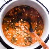 cooked ground turkey soup inside an instant pot with a wooden soup spoon
