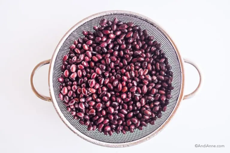 black beans in a metal strainer
