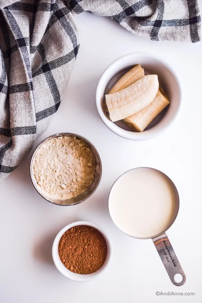 bowls of ingredients on white table and a kitchen towel