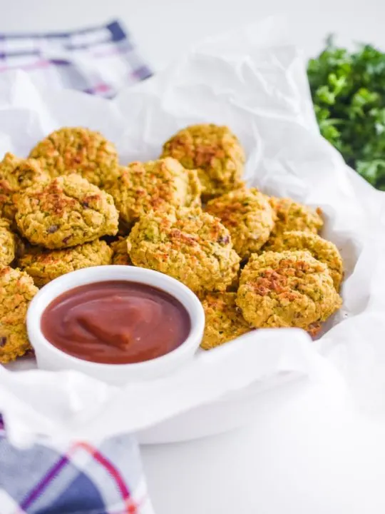 chickpea nuggets in white parchment paper with ketchup