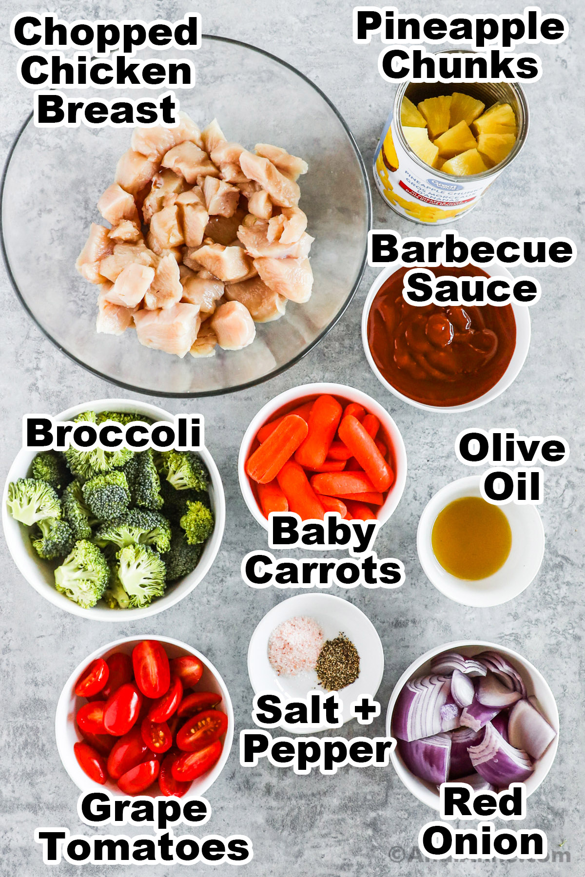 Bowls if ingredients including chopped chicken, barbecue sauce, broccoli, baby carrots, olive oil, tomatoes, red onion, salt and pepper.