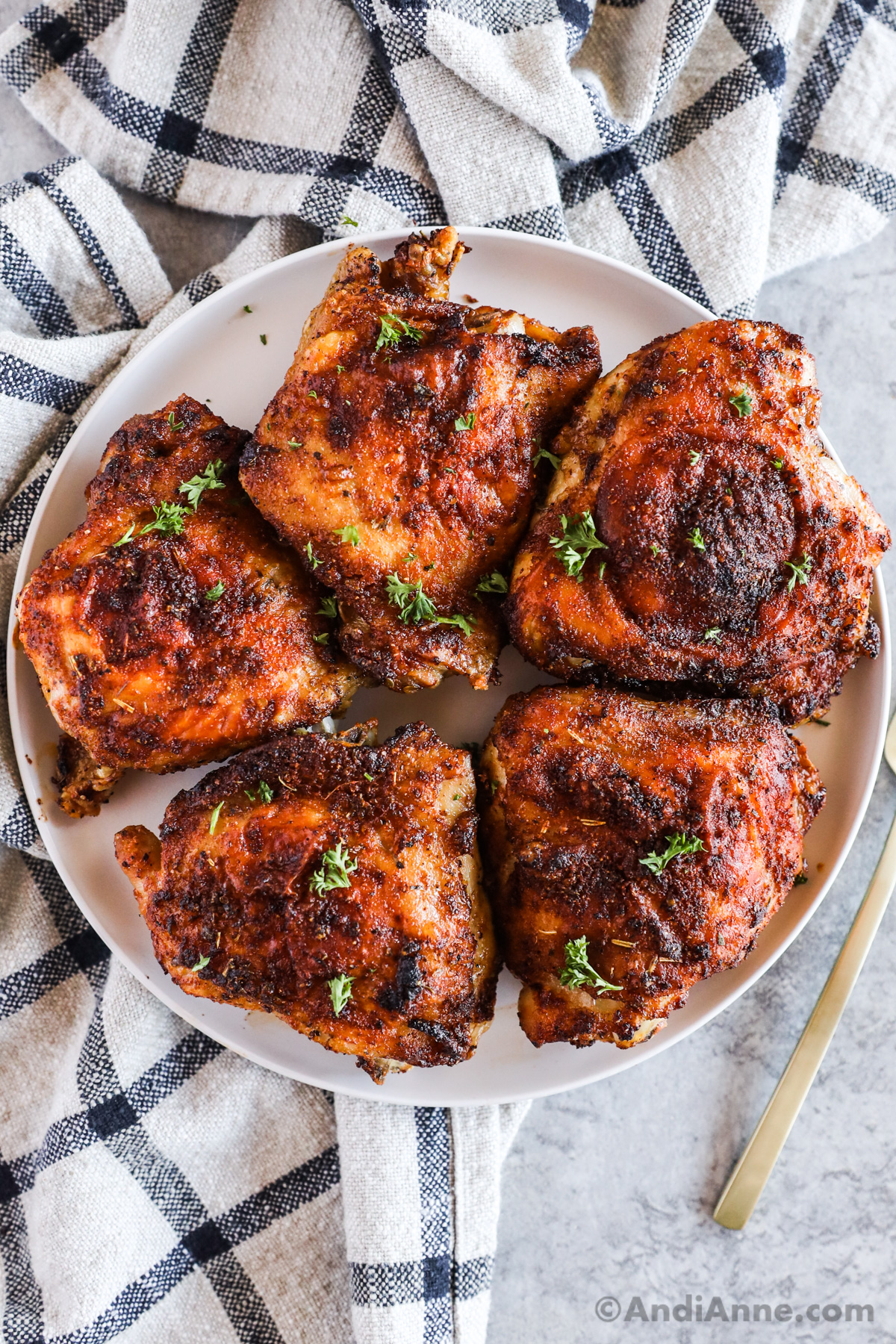 Cooked chicken thighs on a plate. 