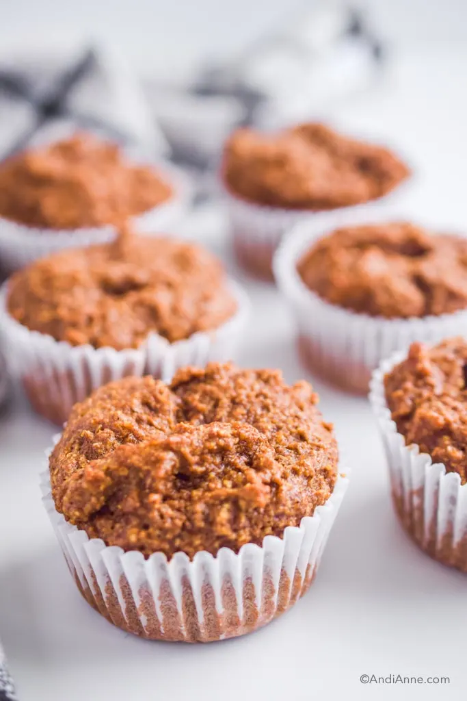 a pile of flaxseed muffins on a white counter.