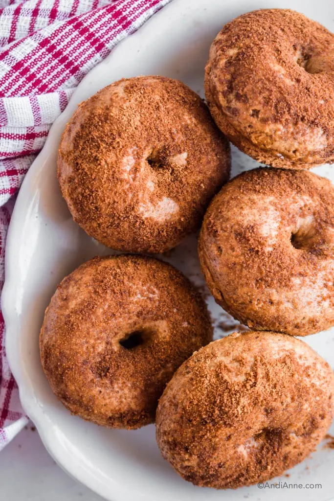 Stack of cinnamon sugar baked donuts in a white bowl