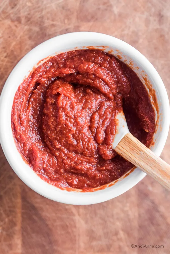keto barbecue sauce in a white bowl with spatula