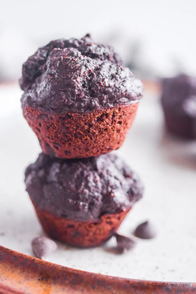 chocolate protein muffins stacked on top of eachother close up
