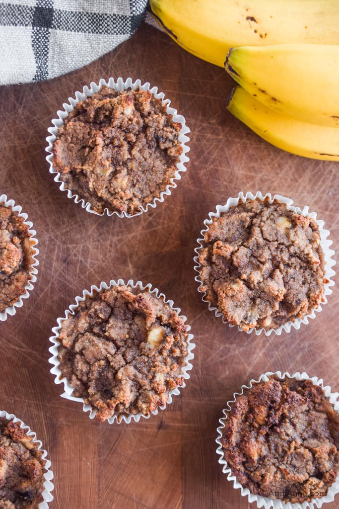 coconut flour muffins on a cutting board with yellow banana in top right corner of image