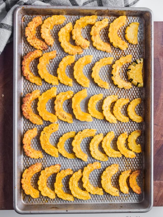 slices of delicata squash on a baking sheet