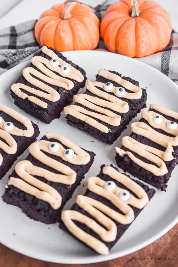 Side angle of the halloween chickpea brownies on a white plate.