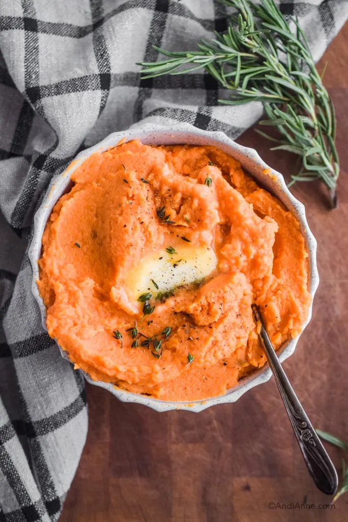 Looking down at mashed potatoes in a bowl with a serving fork.