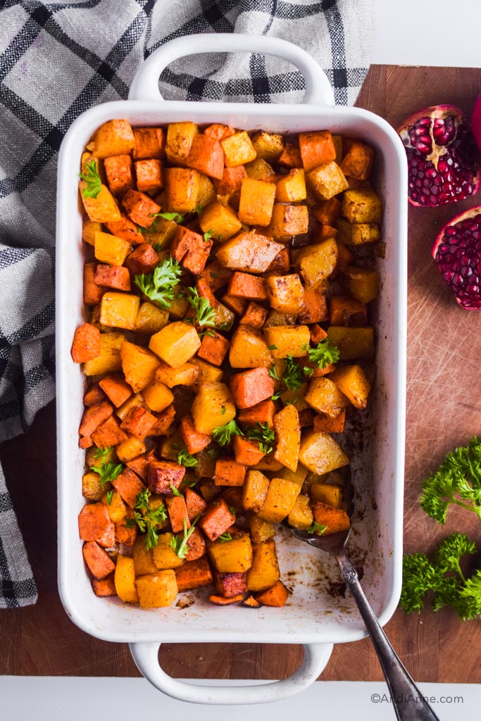 roasted squash and sweet potato with cinnamon in a white casserole dish.