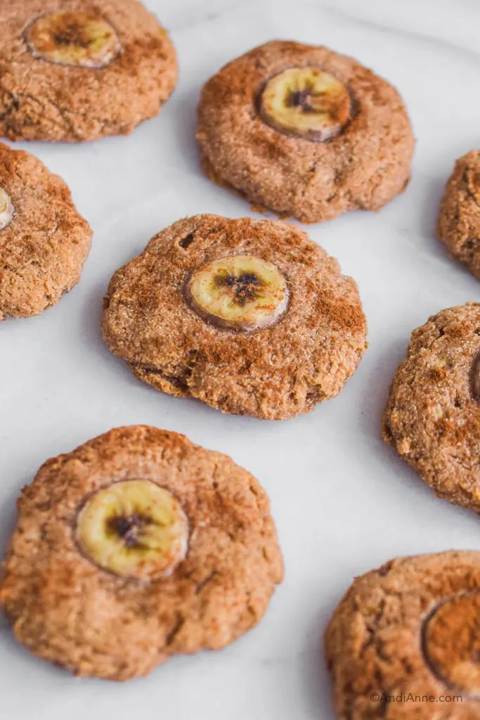 A bunch of banana oat cookies placed on white marble counter