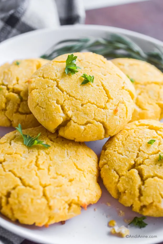 close up of keto coconut flour biscuits with bits of green parsley on top