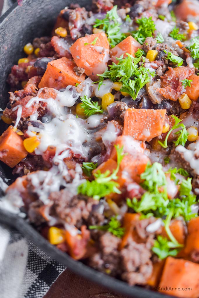 Close up of ground beef sweet potato skillet with melted mozzarella cheese.